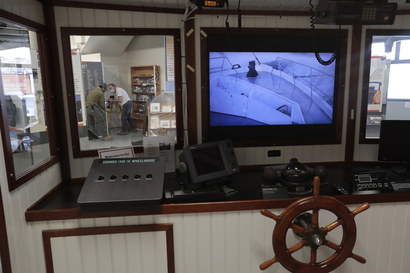 Matt Walsh and Stephen Walsh of WB Inc. carpenters, are seen through one of the windows on the bridge found inside of he New Bedford Fishing Heritage Center on Bethel Street in New Bedford, which is undergoing major renovations including More than a Job: Work and Community in New Bedford's Commercial Fishing Industry.  The new exhibits are scheduled to open soon. PHOTO PETER PEREIRA