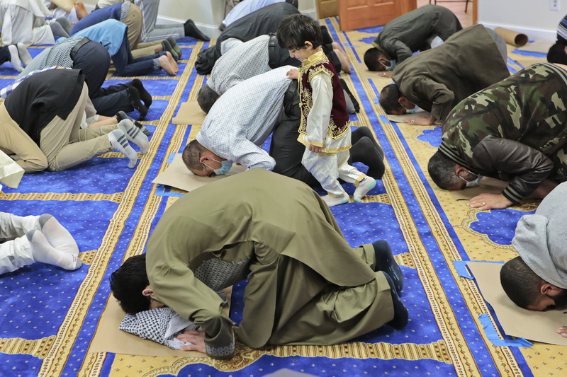 Adnan Amara, 3, looks on as his father Aziz Amara joins fellow parishioners for the Eid prayers celebrating the end of Ramadan at the Masjid Al-Ehsan mosque on Cove Road in Dartmouth, MA. PHOTO PETER PEREIRA