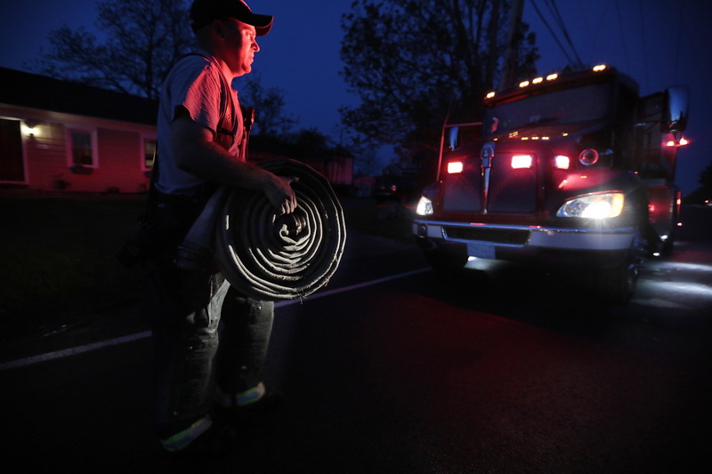 Firefighter Zack Petitpas of the Freetown fire department responds to a brush fire on Perry HIll Road in Acushnet, MA.  PHOTO PETER PEREIRA