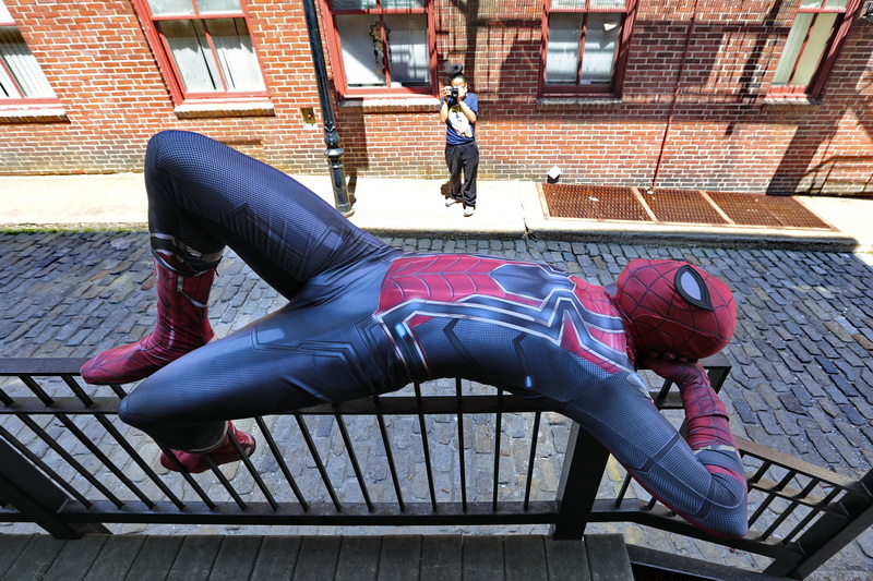 FImalay Lugo of Ever After, takes a photo of Spider-Man (Jalen Latimer) resting on the rail of an alleyway in downtown New Bedford, for promotional materials for the New Bedford character company.  PHOTO PETER PEREIRA