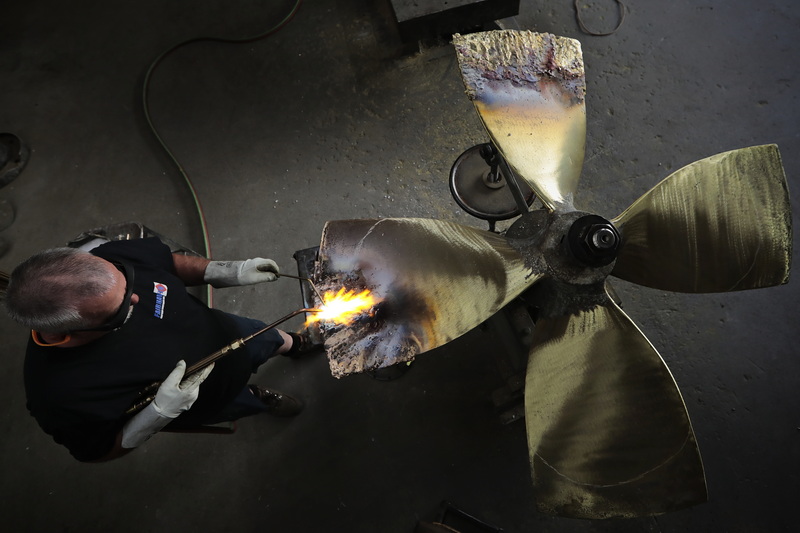 John DeMello, propeller technician at Scandia in Fairhaven, MA uses a torch to repair the propellor from a fishing boat. PHOTO PETER PEREIRA