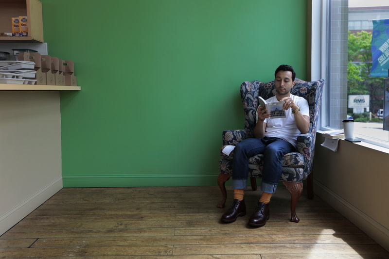 Richard Masciantonio takes shelter from the heat, outside to read How to Read Buildings, a book he picked up at the downtown library, over a cup of coffee inside the airconditioned comfort of The Green Bean on Union Street in New Bedford, MA.  PHOTO PETER PEREIRA