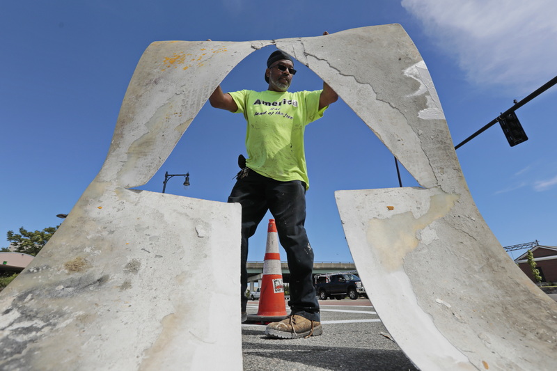 Arthur Correia uses stencils to re-paint the lines and arrows at the Elm Street and Route 18 intersection in downtown New Bedford, MA.  PHOTO PETER PEREIRA