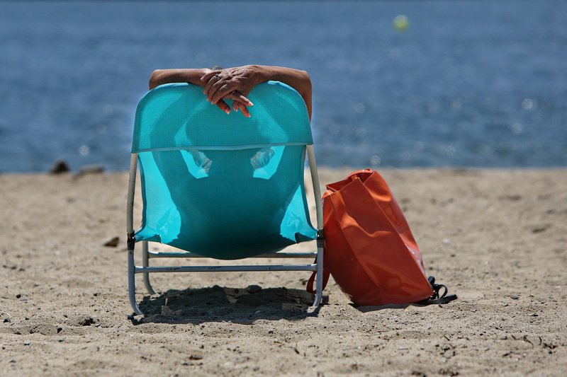 A woman enjoys heat wave making its way across the region, by catching some sun rays at East Beach in New Bedford. PHOTO PETER PEREIRA