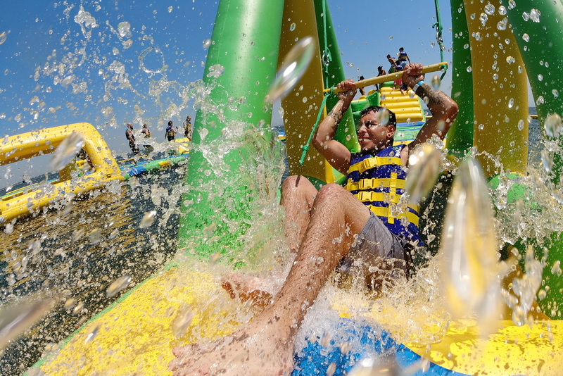 Domingo Garcia takes shelter from the sweltering heat by enjoying himself at the newly opened Whoa Zone water park installed off of East Beach in New Bedford, MA. PHOTO PETER PEREIRA