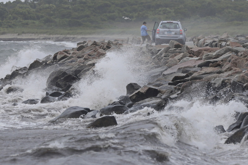 A motorist who had stopped on the causeway to Gooseberry Island in Westport, struggles to re-open the door due to the high winds as tropical storm Elsa makes its way across the region.  PHOTO PETER PEREIRA