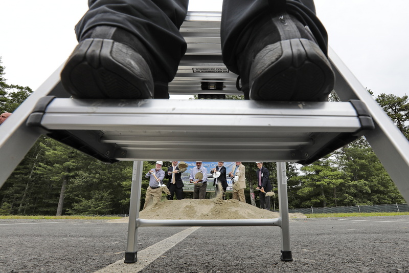 A photographer stands on a step ladder, to take a photo of the official groundbreaking of the future site of the Tonix Pharmaceuticals plant at the New Bedford Industrial Park. PHOTO PETER PEREIRA