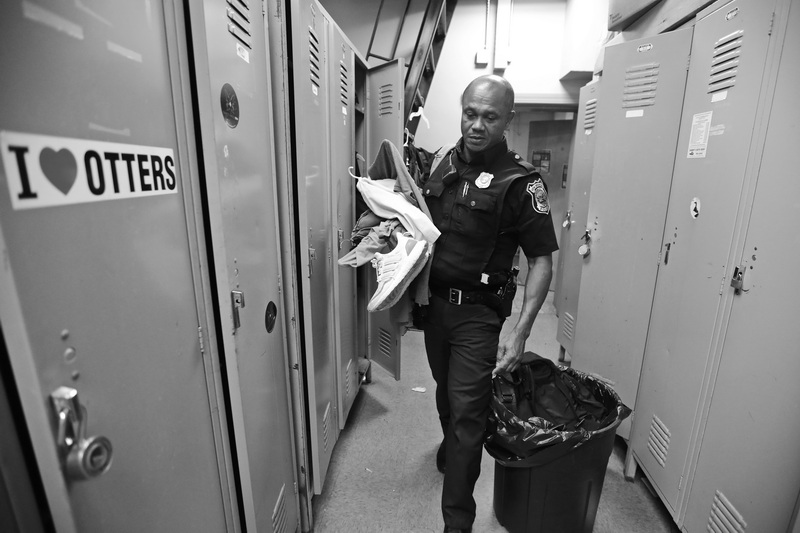 Officer Carlos DePina moves his personal items out of his locker during the last day of operation for New Bedford police Station 2 on Cove Street in New Bedford, MA.  Both New Bedford fire and police south end stations are relocating to a new combined station on Brock Avenue.  PHOTO PETER PEREIRA