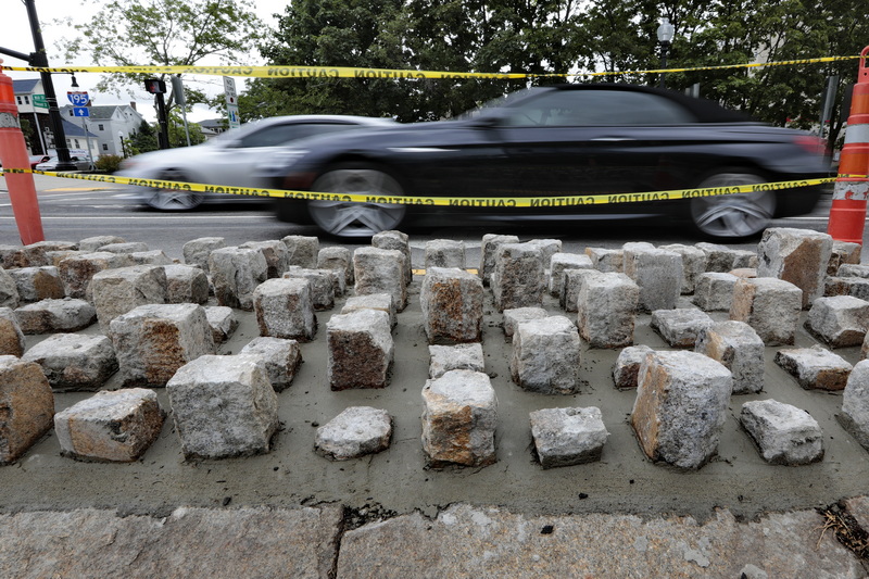 Cars pas the newly installed cobbles lining Route 6, at the Pleasant Street intersection in New Bedford, MA.  PHOTO PETER PEREIRA