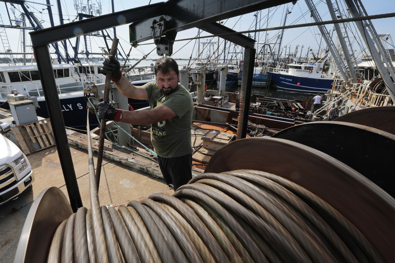 Dumieru Babes of New Bedford Ship Supply, uses a steel rod to weave the 1 1/8