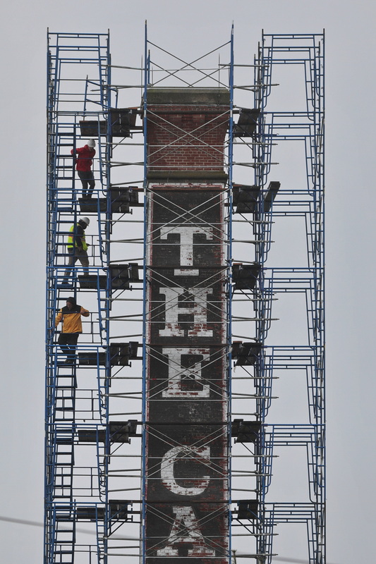 Three men find themselves high above New Bedford, MA as they inspect the chimney of The Car Barn apartment complex, currently undergoing repairs.  PHOTO PETER PEREIRA