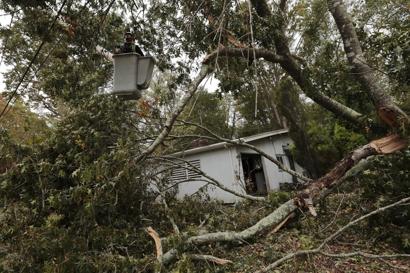 Richard Meack of Barnes Tree Service finds himself up high cutting apart a tree that fell onto a home on Brownell Avenue in Dartmouth due to the nor'easter that swept across the Northeast.  PHOTO PETER PEREIRA