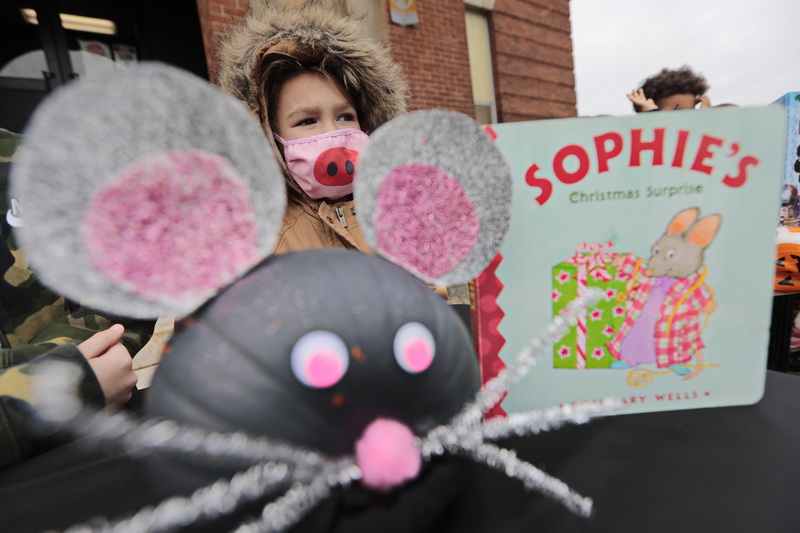 Sophia Souza shows off the pumpkin that she made in the likeness of the character she read in the book seen to the right. Kindergartners of the Swift School in New Bedford participate in the Character Pumpkin Parade featuring pumpkins they decorated with the help of their families and reflect a character they read in a book in class. PHOTO PETER PEREIRA