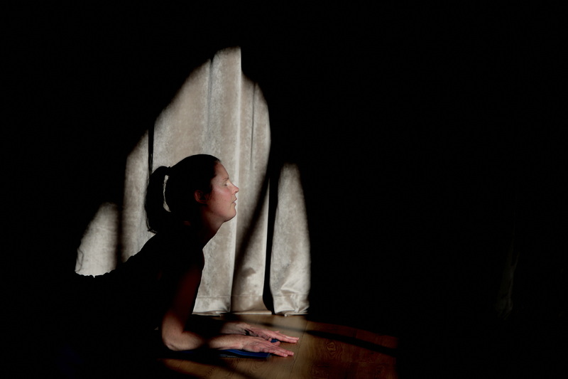 Yoga instructor Kim Rioux is framed by the light coming in through the window, as she conducts class at the new Sangha which has opened at 693 Purchase Street in downtown New Bedford at the old Edison Light Building.  PHOTO PETER PEREIRA