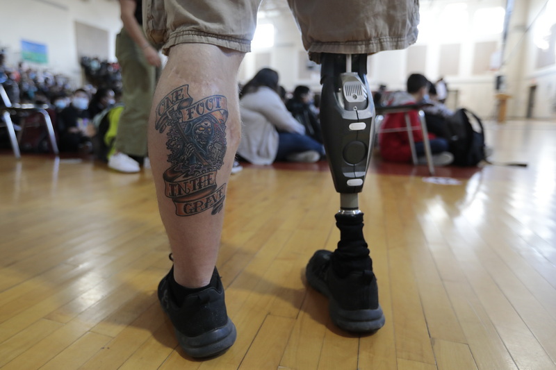 Army Iragi War veteran, Christopher Gomes, looks on during the Roosevelt Middle School Veterans Day Ceremony held in the school's gymnasium. Mr. Gomes lost his right leg when an IED exploded while serving in Iraq in 2008. PHOTO PETER PEREIRA