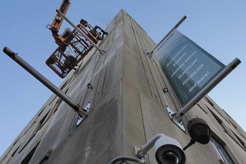 Masons re-point the concrete slabs that make up the sides of the Webb Building, the current Bristol Community College downtown New Bedford, MA campus.  PHOTO PETER PEREIRA