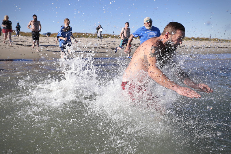 James O'Driscoll, brother of Shannon, dives into the freezing waters off Gooseberry Island in Westport, MA for the annual Plunge of the Faithful in celebrating the life of Shannon O'Driscoll who was killed in 2006 by an SUV driver while holding a sign supporting organized day care programs in the state. The money raised is given to The Neediest Family Fund to help area needy families during Christmas.  PHOTO PETER PEREIRA