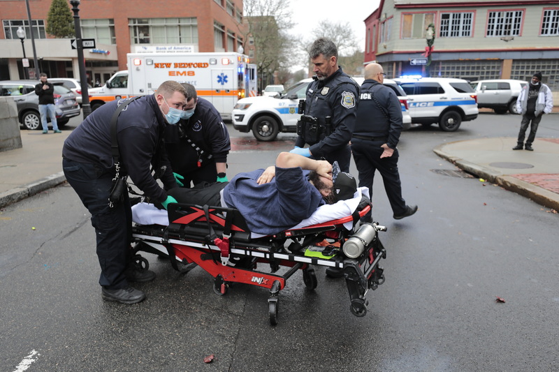 A man winces in pain as New Bedford EMS adjusts the leg he hurt during an altercation with a man at the intersection of Elm Street and Pleasant Street in downtown New Bedford, MA. PHOTO PETER PEREIRA