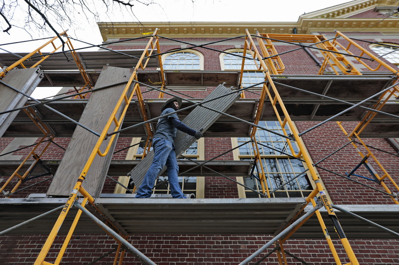 Richard Dubreuil of Paul Choquette & Co. installs staging on the Johnny Cake Hill side of the Whaling Museum, in preparation to repoint the brickwork of the historic building in downtown New Bedford, MA. PHOTO PETER PEREIRA