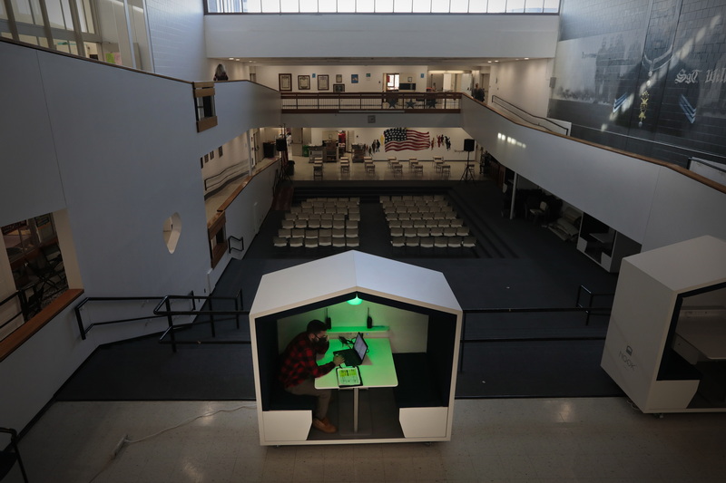 Family engagement support coordinator, Jason Figueroa finds himself inside one of the just assembled Nook Pods installed at Carney Academy in New Bedford, MA.  The pods are designed for one on one talks with students, or for quiet time for either students or staff. PHOTO PETER PEREIRA