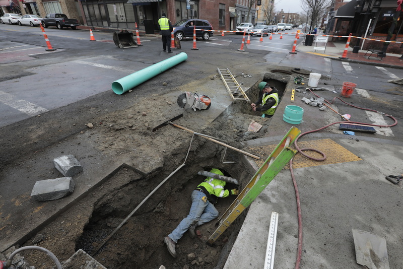 A worker finds himself well bellow ground as he and fellow C. Naughton Corp. technicians install a new drain pipe under Union Street in downtown New Bedford, MA as part of the final phase to re-do the unseen infrastructure underground.