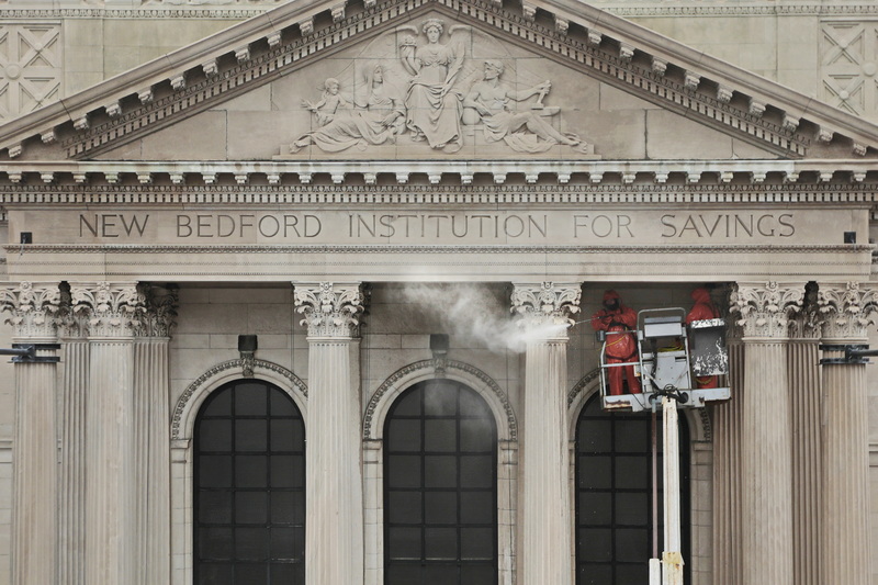 Masonry & Restoration Inc. workmen use a power washer to clean the corinthian columns on the facade of the old New Bedford Institution for Savings building on Union Street in downtown New Bedford, MA. Built in 1896 the classical revival structure was designed by Charles Brigham who also designed the Museum of Fine Arts in Boston and was third largest bank building in the country at time of completion.