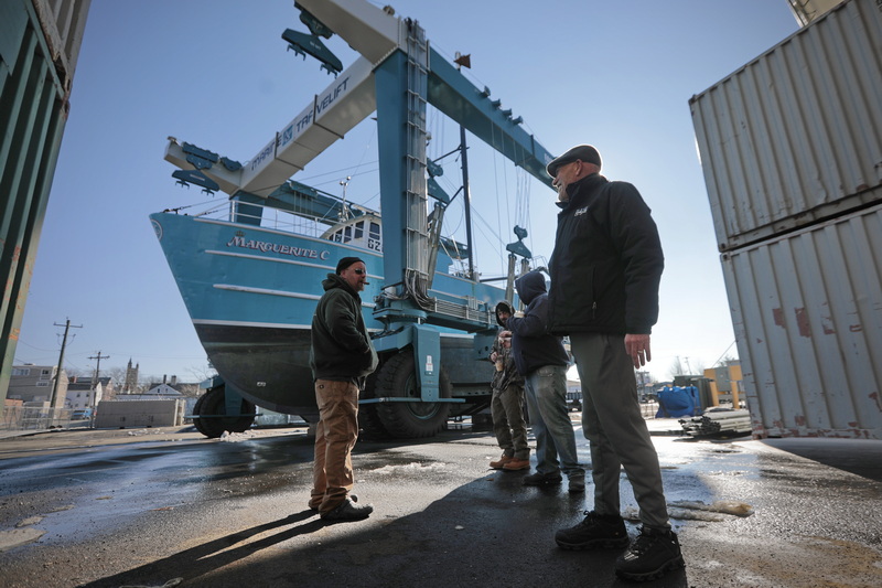 Captain Brian Jannelle, left, owner Raymond Canastra, right are all smiles as they and crew take a closer look at the fishing boat Maguerite C which was modified for groundfishing and had a new keel installed at Fairhaven Shipyard in Fairhaven, MA before it is put back in the water for the first time since major repairs.  Mr Canastra named the boat after his mother just before she passed away at the end of last year. PHOTO PETER PEREIRA