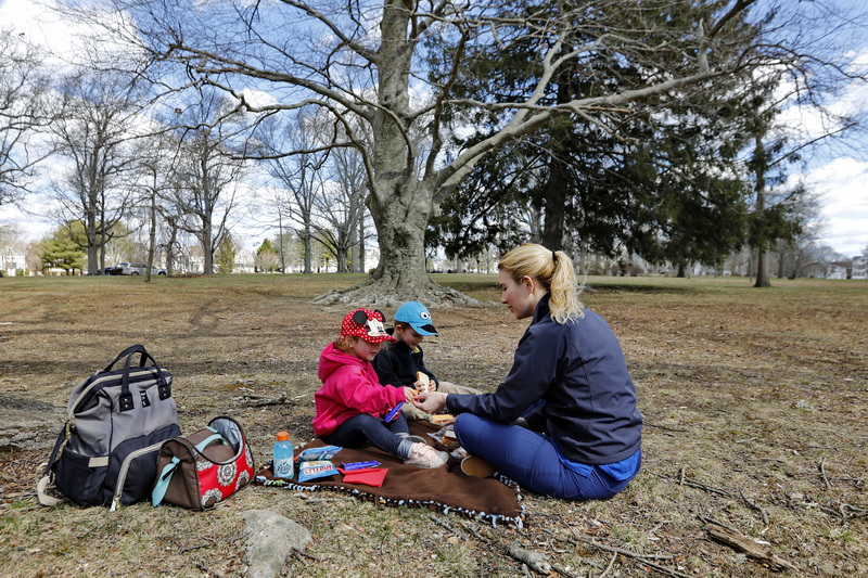 Candace Rego and her two children Bailey Aguiar, 2, and Gavin Aguiar, 4, enjoy the first day of Spring by having a picnic at Buttonwood Park in New Bedford, MA.  PHOTO PETER PEREIRA