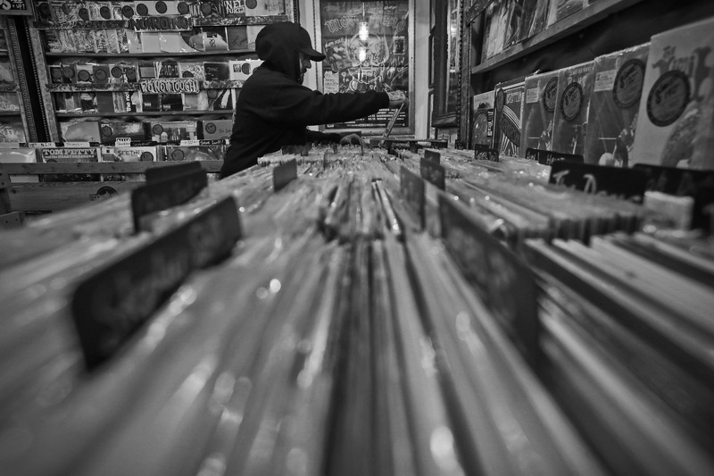 Chris Benvie goes through the vast collection of vinyl records in search for a The Who album, at Purchase Street Records in New Bedford, MA. PHOTO PETER PEREIRA