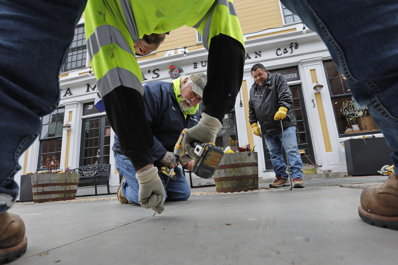 New Bedford Facilities and Fleet Managemen install the outdoor seating area in front of Tia Maria's European Cafe in downtown New Bedford.  These platforms were installed at the beginning of the COVID-19 pandemic to help restaurants deal with seating restrictions, and have been installed in front of select establishments once again this year.  PHOTO PETER PEREIRA