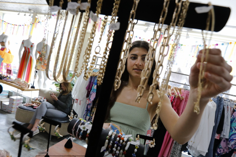 Angela Dawicki waits as her daughter, Hannah Dawicki, looks for some accessories to go with the dress she is buying at Calico in downtown New Bedford, MA for a bridal shower she has been invited to attend. PHOTO PETER PEREIRA