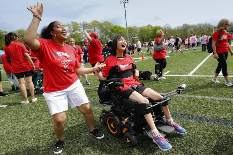 Alicia Broderick, left, and Shinbi Jang dance together during the Special Olympics held at Memorial Stadium in Dartmouth, MA. PHOTO PETER PEREIRA