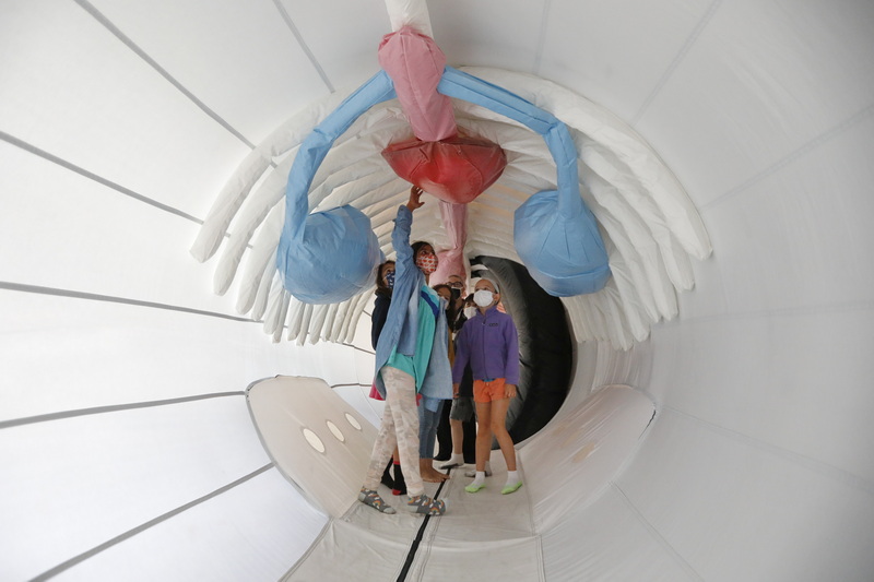 Studens from the Gordon School in Providence touch the heart, as they find themselves inside an anatomically correct inflatable humpback whale now on display in the Harborview Room in the Whaling Museum in New Bedford, MA. PHOTO PETER PEREIRA