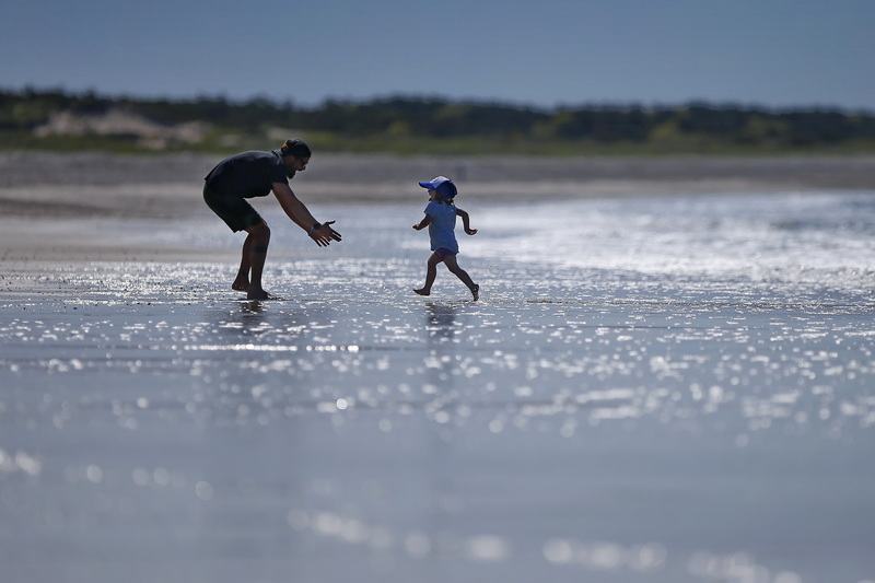 Evie Torres, 2, runs toward her father Gabe Torres as the pair enjoy a beach day together at Horseneck Beac in Westport, MA to celebrate Mr. Torres' birthday. PHOTO PETER PEREIRA