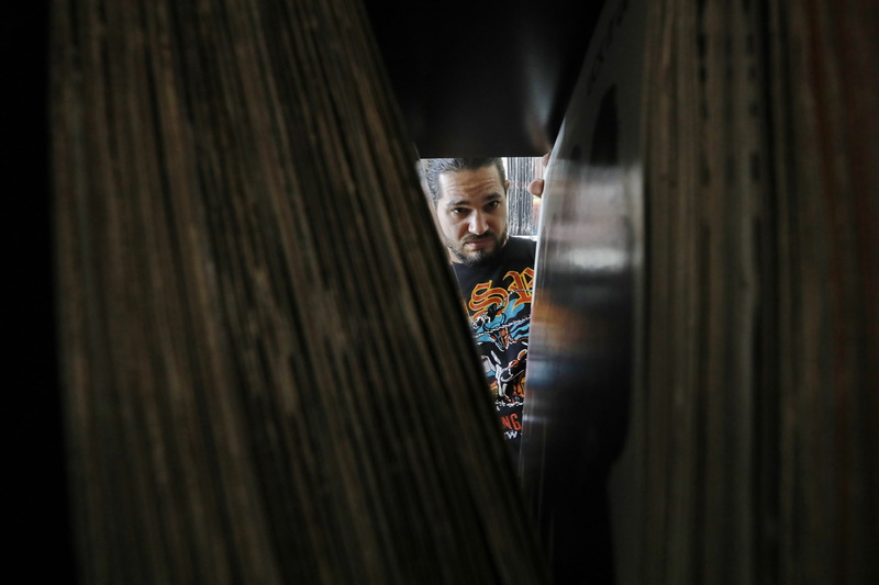 John Sladewski, of Purchase Street Records, files away vinyl records in preparation to open their new location at the former Newsbreak store on Pope's Island in New Bedford, MA. PHOTO PETER PEREIRA