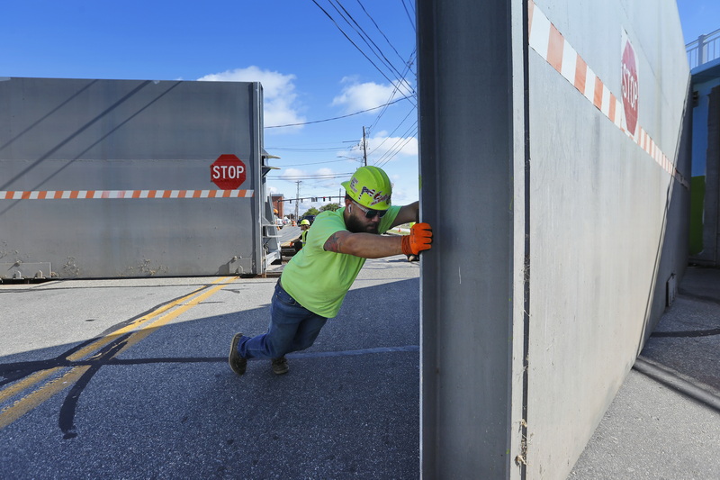 Luis Bula opens one of the massive hurricane barrier doors during the annual New Bedford DPI inspection of the hurricane barrier doors on Cove Road, and other sites throughout the city, in preparation for hurricane season. PHOTO PETER PEREIRA