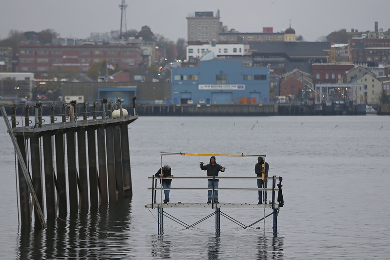 Fairhaven Shipyard workers are seen aligning a device on one of the ramps where ships are pullout out of the water for repairs. PHOTO PETER PEREIRA