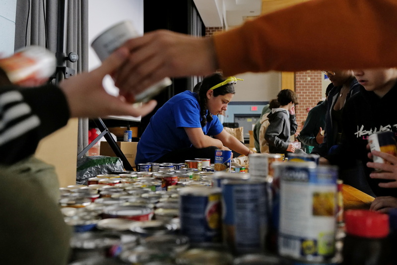 Brooke Pavao, 14, and fellow Normandin Middle School eighth graders sort the thousand of non-perishable food items they collected during the school year, to be given to those in need at Thanksgiving. PHOTO PETER PEREIRA