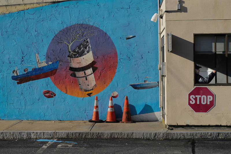 Bank of America parking lot security officer, Bob Pinnell, is surrounded by artwork as he sits in his booth outside of the downtown New Bedford, MA branch. PHOTO PETER PEREIRA