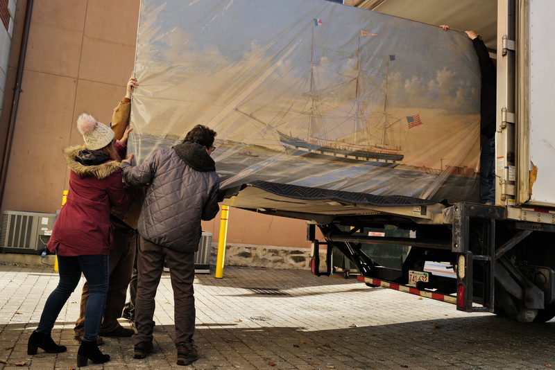 Whaling Museum's Melanie Correia, exhibition manager, and D. Jordan Berson, Director of Collections, help load a painting of the whaling ship Niger being sent for restoration. This painting along with a series of other paintings of whale ships date to the late 1800's and were part of a panorama which told the journey of the whale ship Niger before it was cut into a series of panels (this being one of them) in 1958.  PHOTO PETER PEREIRA