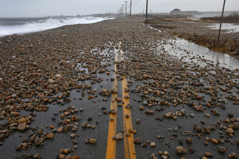 Rocks thrown up by the high surf and wind cover East Beach Road in Westport, MA after a storm surge made landfall across the SouthCoast flooding many coastal areas. PHOTO PETER PEREIRA