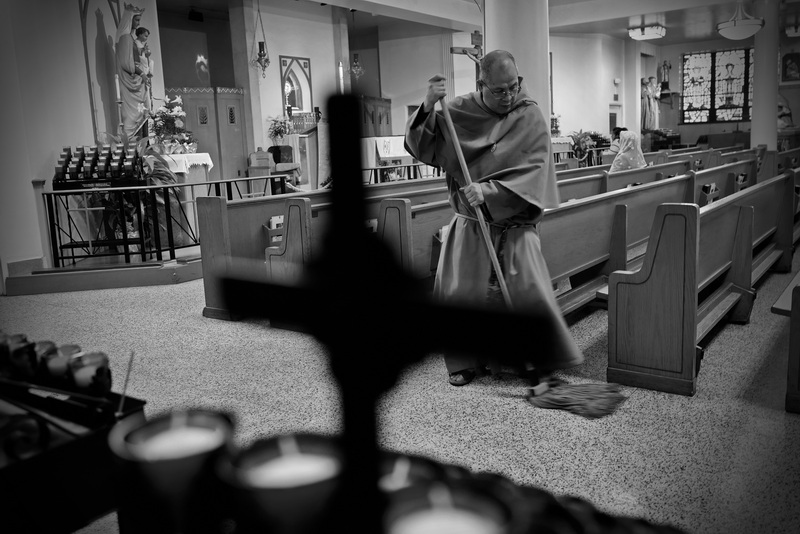 Franciscan Father Isidora Cipres mops Our Lady's Chapel in downtown New Bedford, MA as part of their bi-monthly cleaning duties. PHOTO PETER PEREIRA