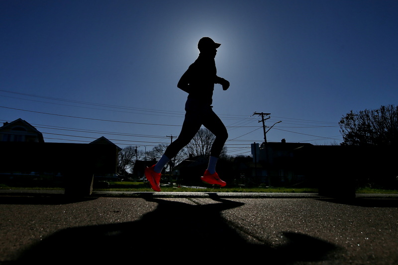 A man goes for an early morning run around the south end of New Bedford, MA.  PHOTO PETER PEREIRA