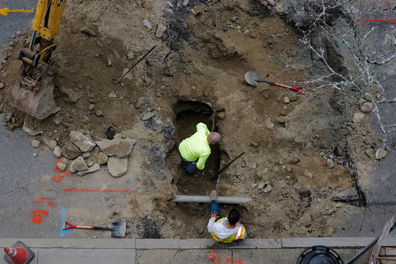 Work crews dig a hole on Elm Street in New Bedford, MA as seen from the top of the public parking garage. PHOTO PETER PEREIRA