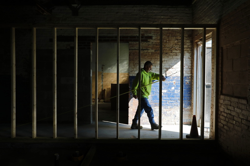 Henry Aguiar of Aguiar Construction measures the new entrance floor slab before etching expansion joints at the West Beach Bathhouse being renovated on West Rodney French Boulevard in New Bedford, MA. PHOTO PETER PEREIRA