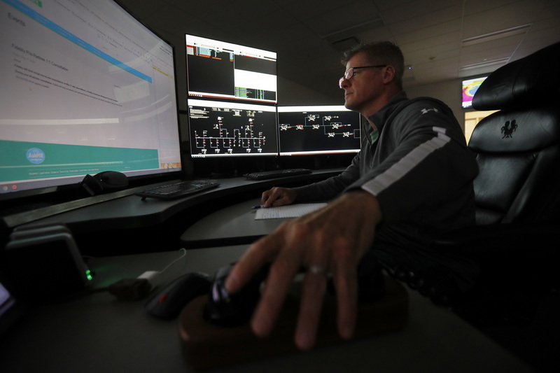 Tom Hanifin, New Bedford area dispatcher, hangs up after taking a new transformer call at the Eversource state-of-the-art control center at their facility in the New Bedford, MA industrial park. PHOTO PETER PEREIRA