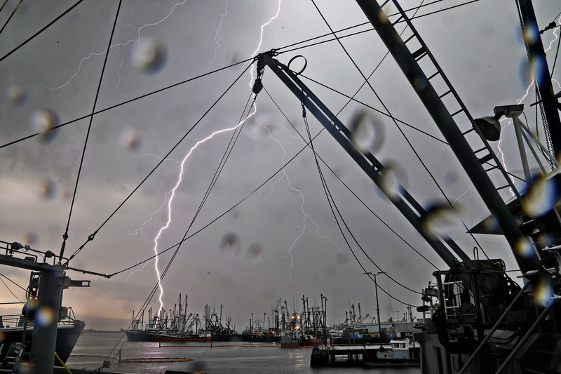 Lightning bolts fall across the New Bedford fishing fleet as a storm rolls over the region.   PHOTO PETER PEREIRA