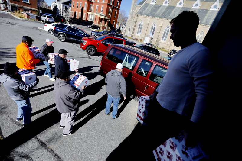 Friendly Sons of St. Patrick load boxes of turkeys onto vehicles in front of St. Lawrence church in New Bedford, MA.  These vehicles will bring them to various organizations around the SouthCoast to be given to the needy for Thanksgiving PHOTO PETER PEREIRA