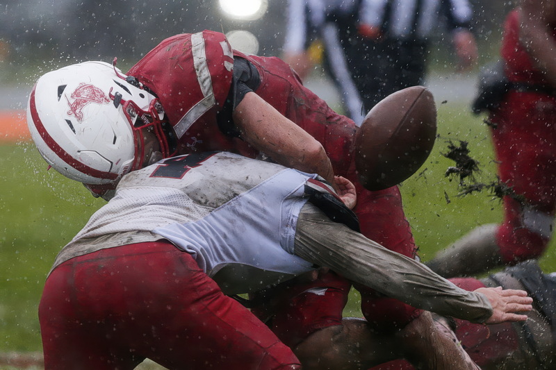 New Bedford's Aliaz Colon fumbles the ball after being hit by Durfee defensive back Kayden Kheav during New Bedford High School against Durfee High School on Thanksgiving Day football.