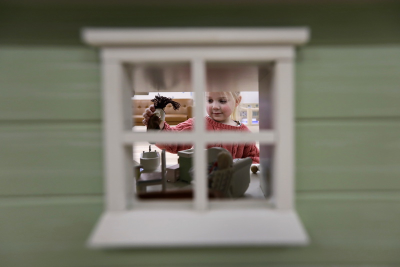 Pearl, 3, plays with a doll as seen through the window of a doll house at the newly opened Play Haven on Route 6 in Fairhaven, MA.  PHOTO PETER PEREIRA